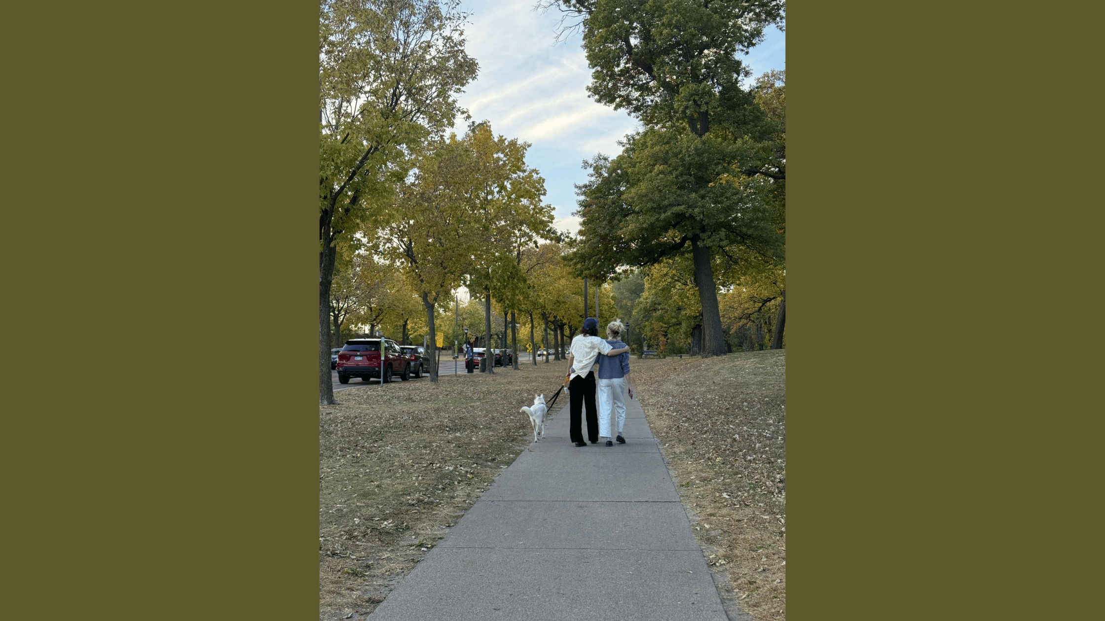 One friend comforting another with an arm around their shoulder while walking together